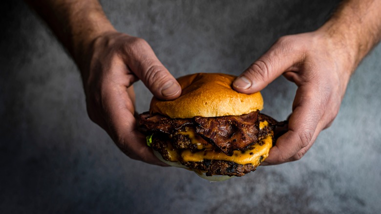 hands holding a smash burger