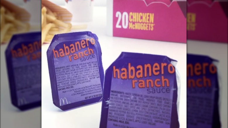 Two habanero ranch sauce dips from McDonald's with chicken McNuggets and fries