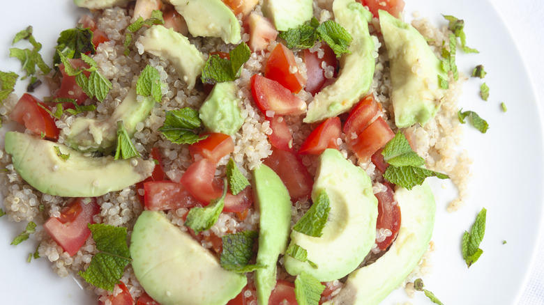 tomatoes avocado and grains dressed in a salad