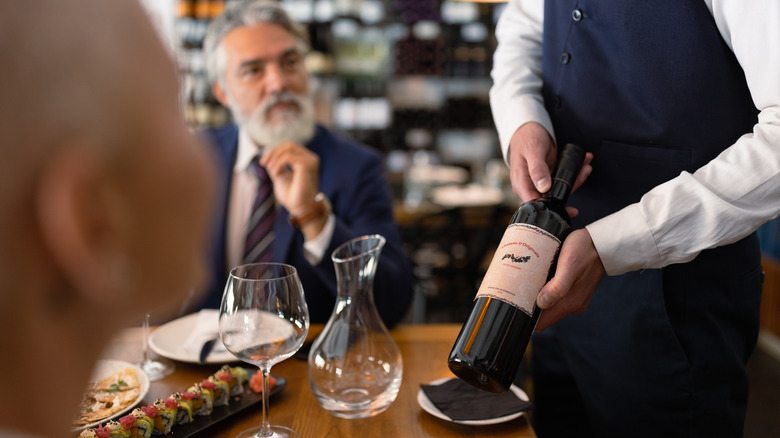 Close-up on a sommelier serving wine