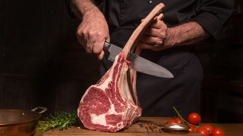 Person cutting steaks