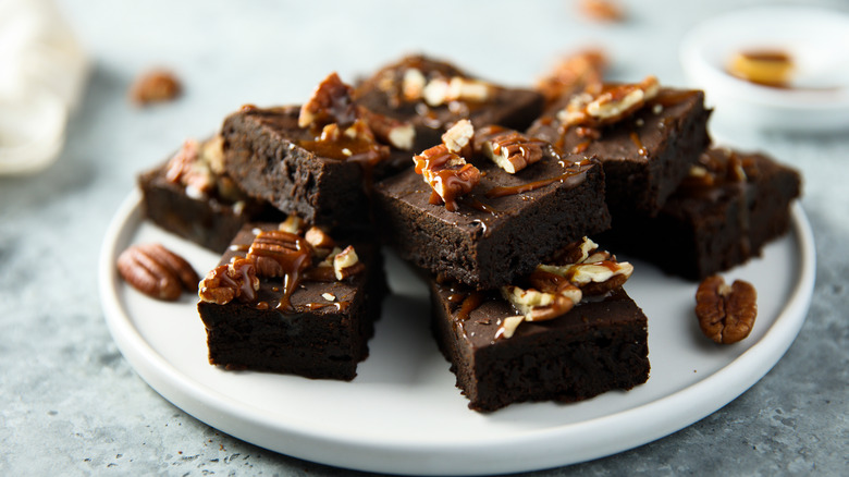 Chocolate brownies with walnuts and caramel on a plate