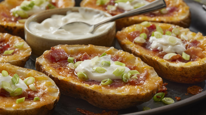 Potato wedges with cheese, bacon, and sour cream
