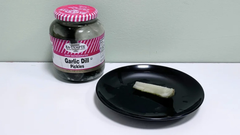 Ba-Tampte Garlic Dill Pickles jar and on black plate; light background