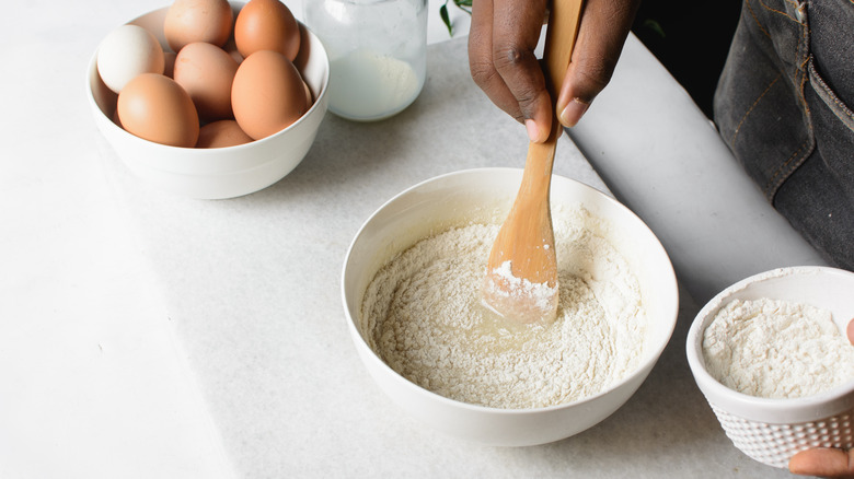 Person mixing cake mix in bowl