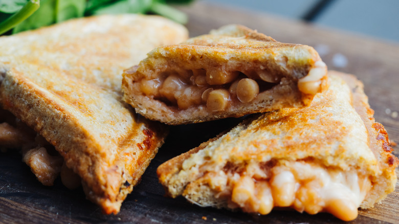 baked bean sandwich covering wood
