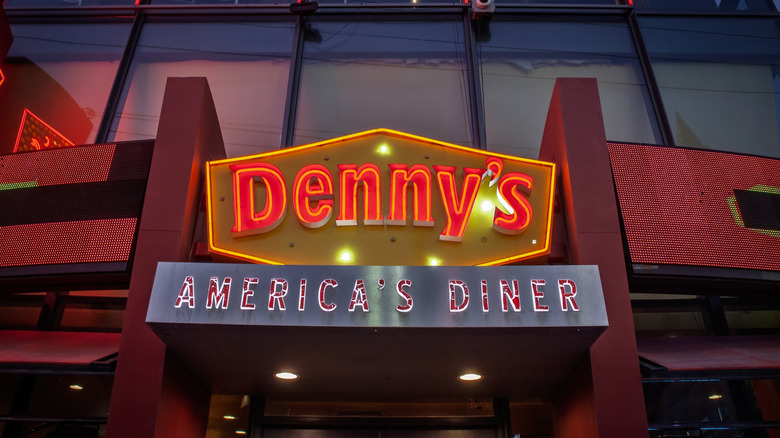 A neon Denny's sign at night