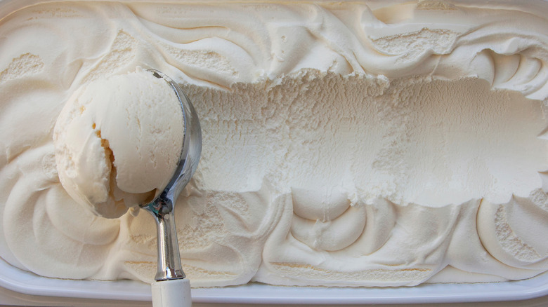 scooping vanilla ice cream