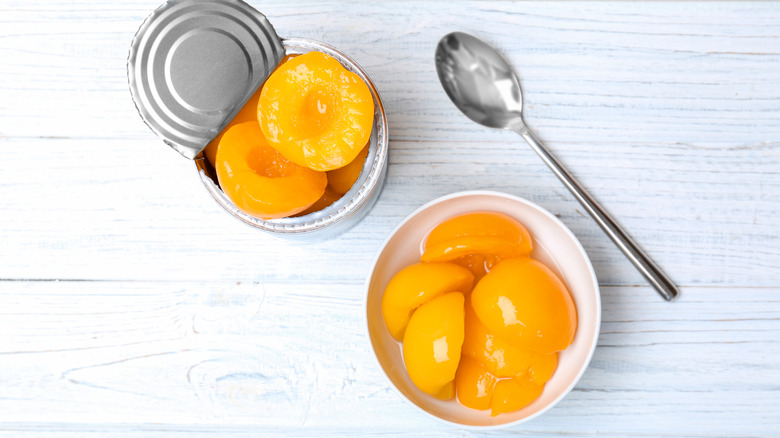 canned peaches in a bowl with syrup
