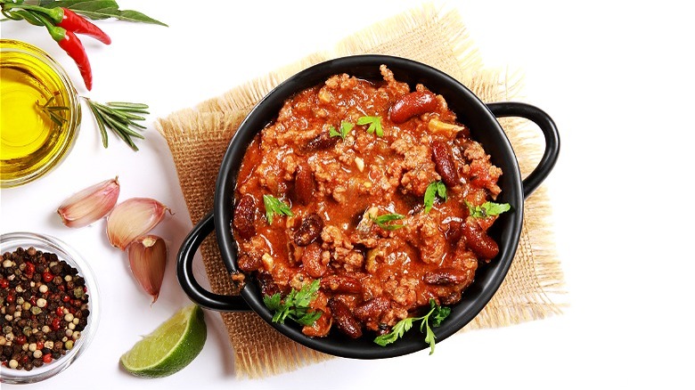 Pot of chili with cilantro and lime