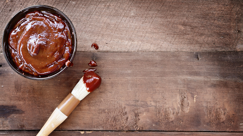 bowl of barbecue sauce and brush