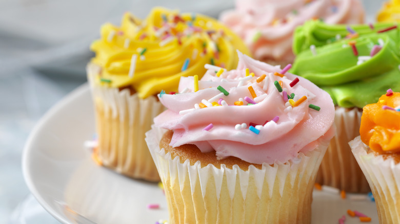 cupcakes decorated with different colored frosting