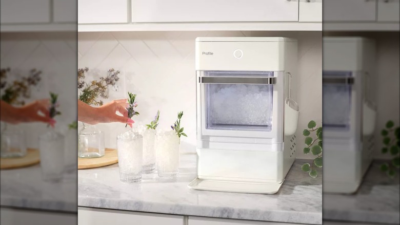 Hearth & Hand GE Profile Opal Nugget Ice Maker filled with nugget ice, next to three glasses of ice.