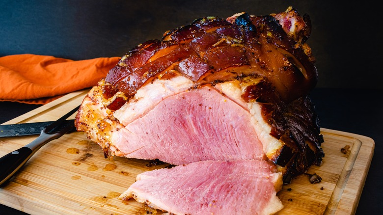 Sliced glazed ham on cutting board