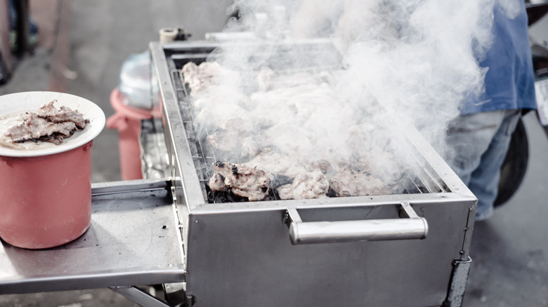 Grill with lots of smoke coming from it