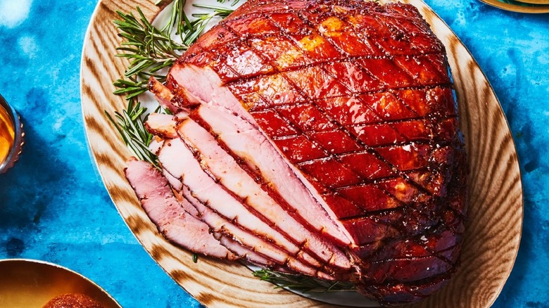 glazed ham on wooden platter