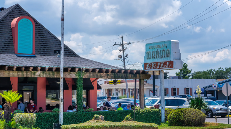 An exterior photo of Russell's Marina Grill, with its signature blue and red neon sign