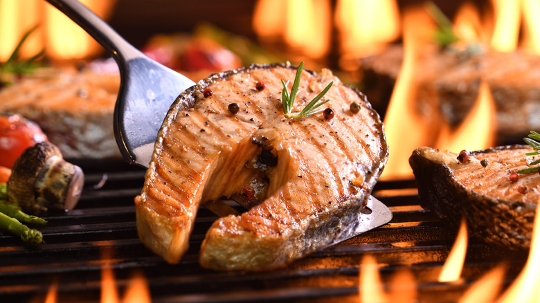 Salmon steak on grill with spatula