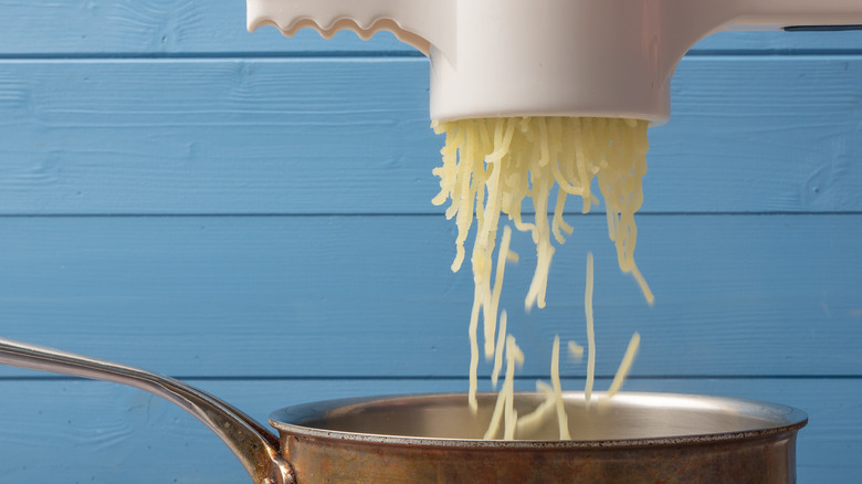 Action shot of ricing potatoes