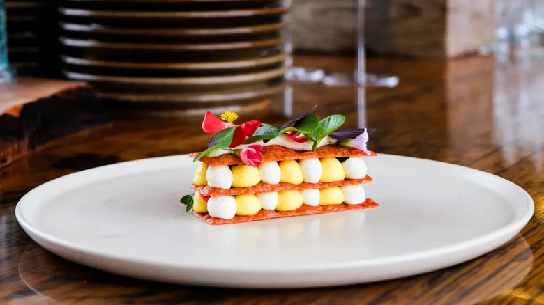 Colorful dessert, decorated with leaves and flowers, at Restaurant Pearl Morissette