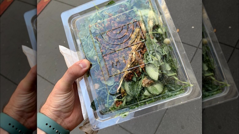 Hand holding mixt salad