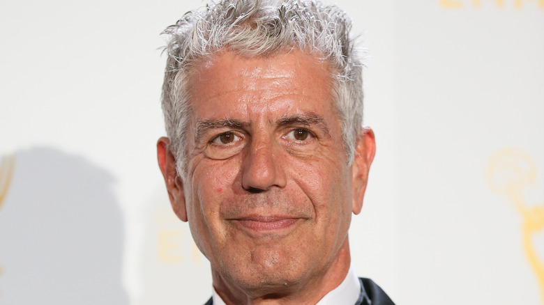 Bourdain poses at event