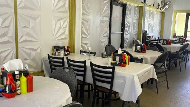 Tables inside Mr. BG's Diner with black and red tablecloths