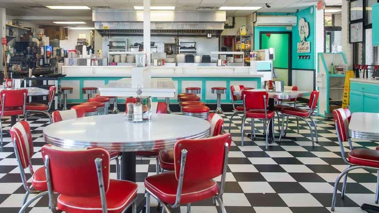 Retro-styled interior of Louie's Café in Baton Rouge with metal furniture and a checkerboard floor