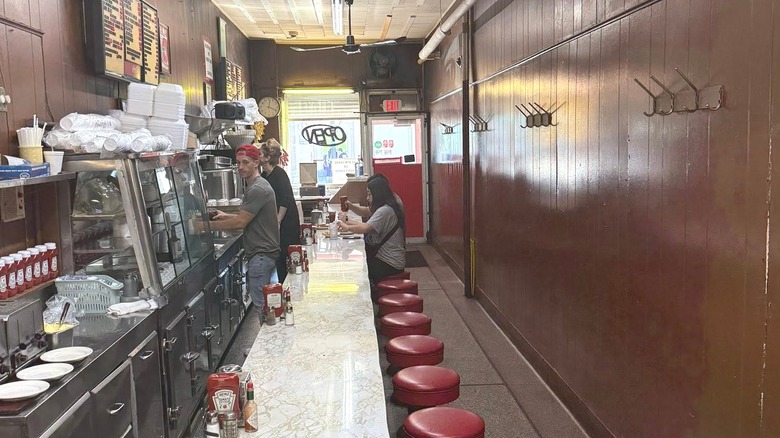 Small interior of Duly's Place Coney Island with people sitting at the counter