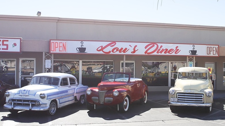 Exterior of Lou's Diner, with some vintage cars parked outside