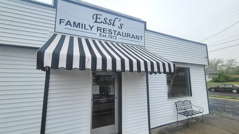 Exterior of Essl's Dugout with a black and white striped awning