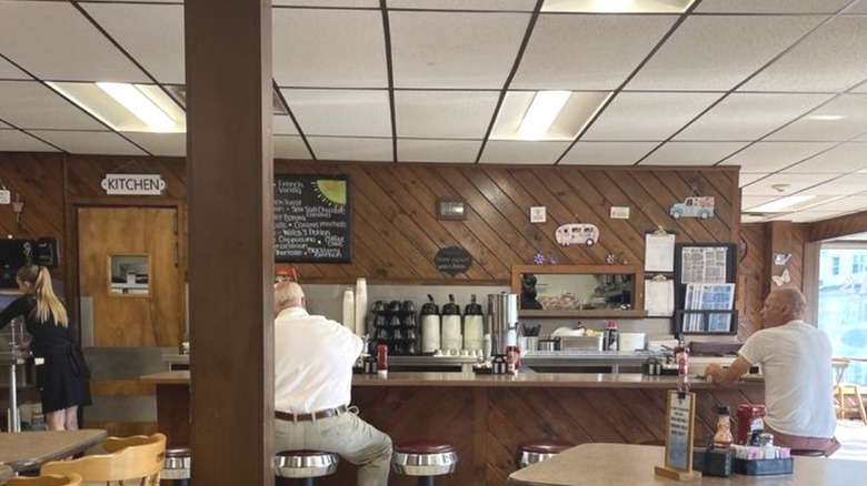 Wooden panelling and stools at the counter inside AJ's Restaurant