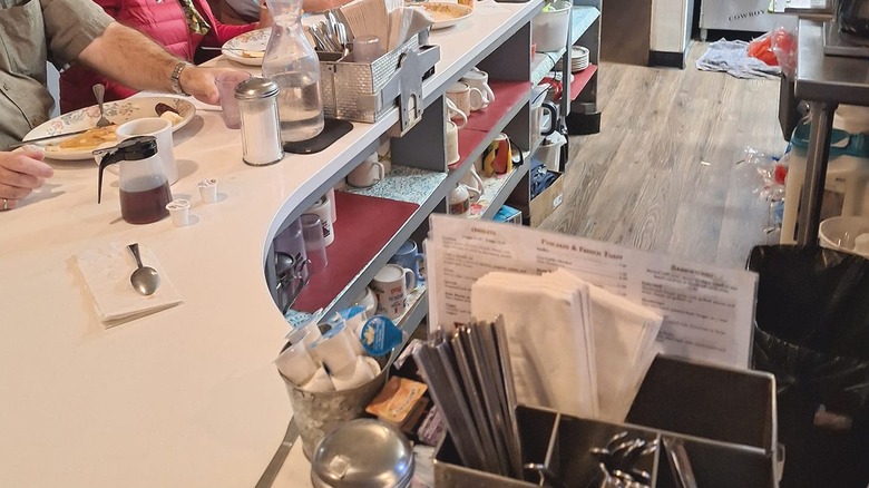 The counter of Silver Spur Cafe with people eating breakfast