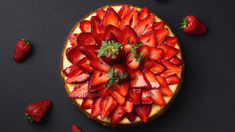 overhead view of cheesecake topped with glazed strawberries