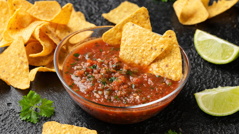 Triangle-shaped chips in a bowl of salsa