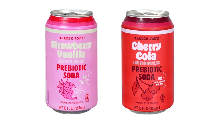 Cans of Trader Joe's Strawberry Vanilla and Cherry Cola-flavored prebiotic sodas.