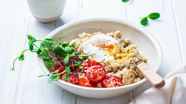 bowl of oatmeal with eggs and veggies
