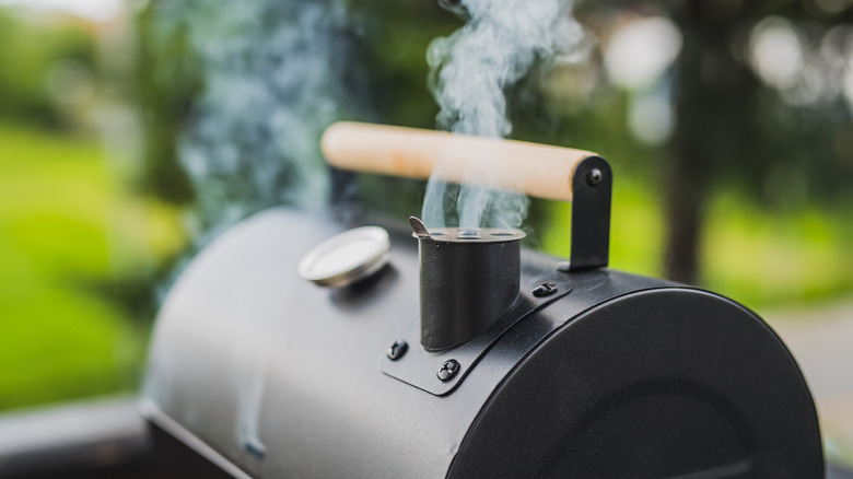 Smoke rising from outdoor smoker grill