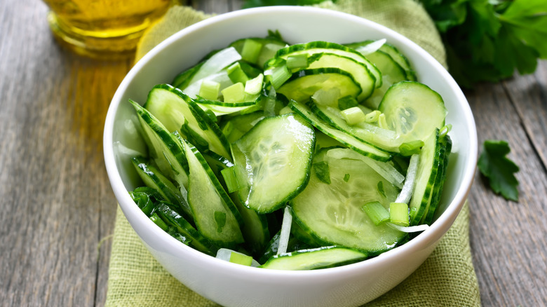 Cucumber salad in white bowl