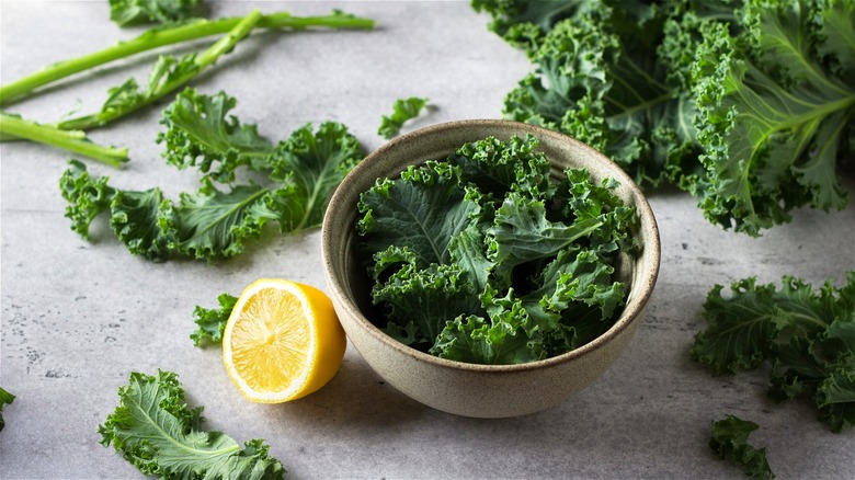 Raw kale in bowl with lemon 