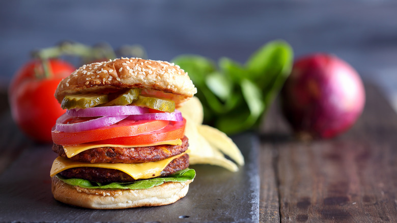 Double decker veggie burger with tomato onion slices