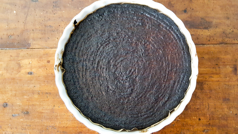 Burnt cake on wood background