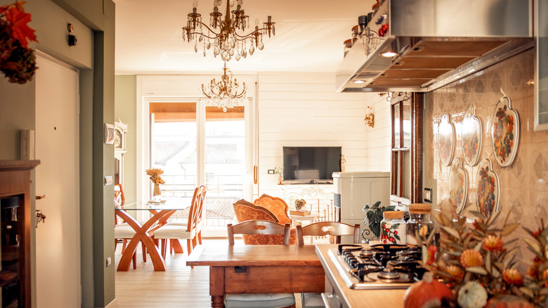 Warmly lit kitchen with tables