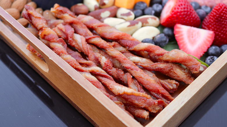Twisted bacon on serving board