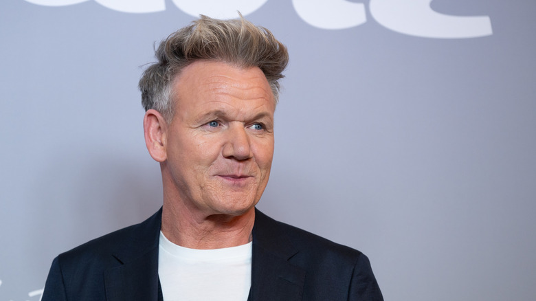Profile of Gordon Ramsay in a white shirt and black blazer, looking off to the side