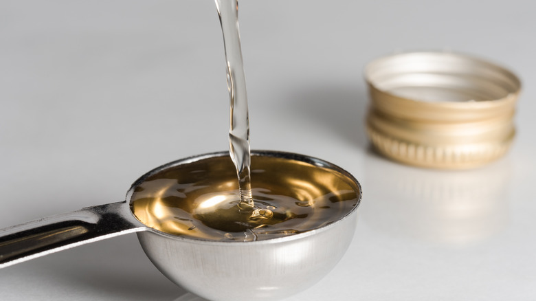 White wine vinegar poured into a spoon