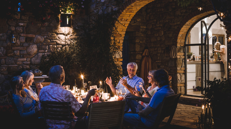 people around table eating outdoors