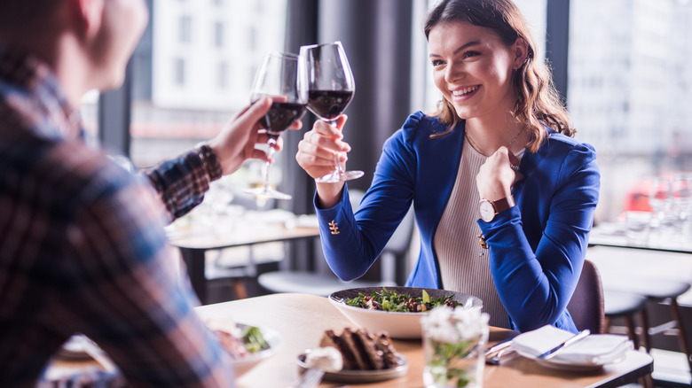 Couple clinking wine glasses