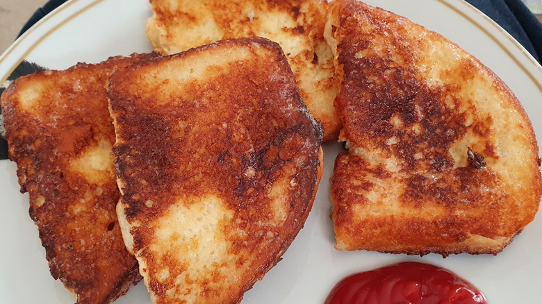Fried eggy bread with ketchup on a plate