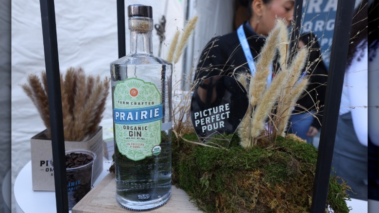 A bottle of Prairie Organic Gin next to a display with wheat